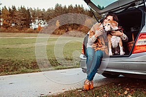 Woman with dog sit together in cat truck and warms Ãâ ÃËÃÂµÃâ¬ hot tea. Auto travel with pets concept image photo